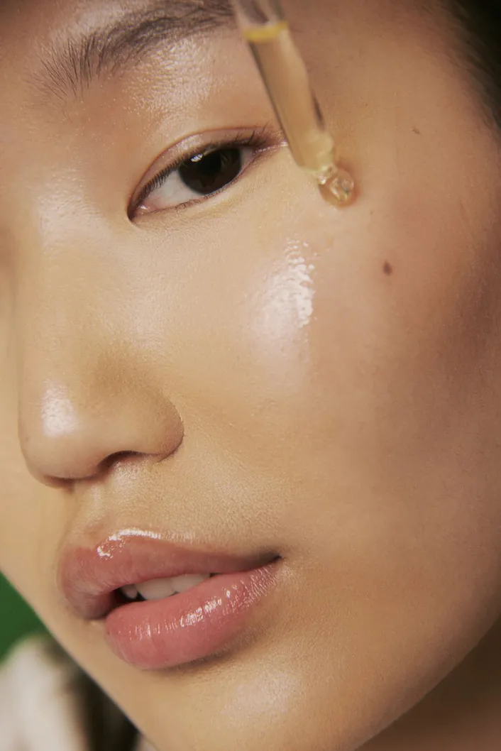 Applying facial serum — skincare layering