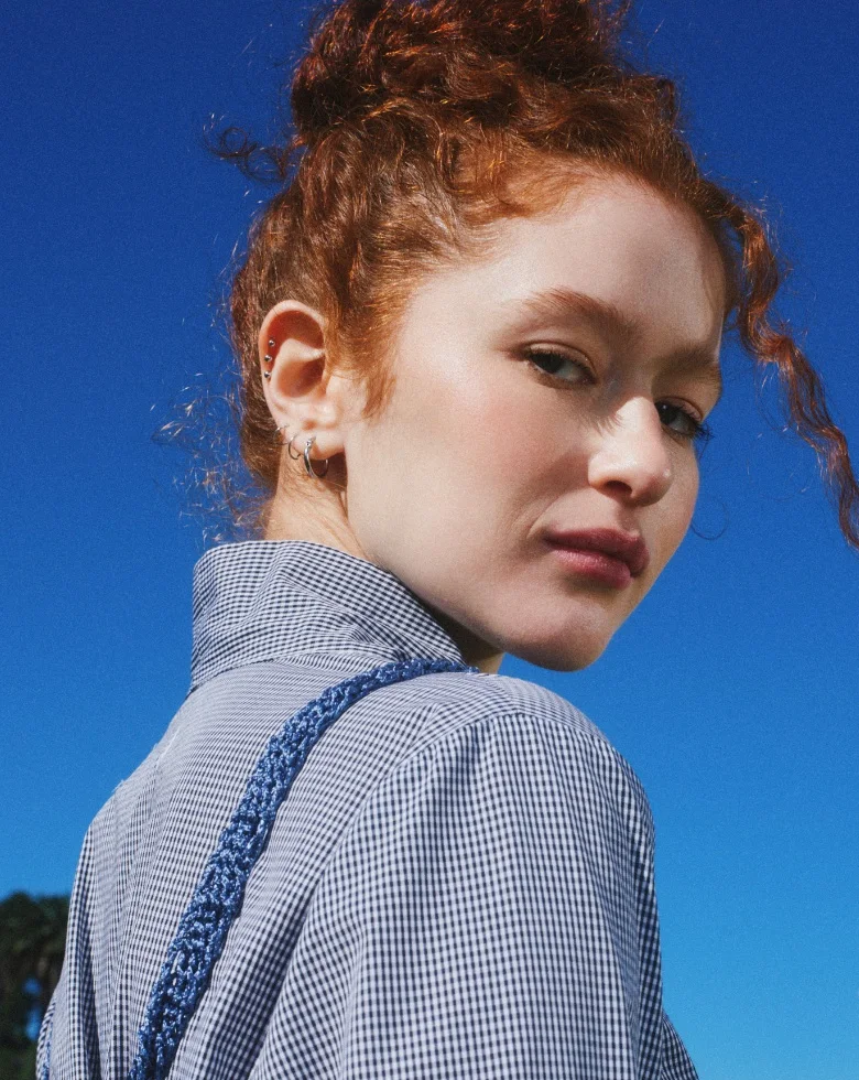 Fresh, porcelain-clear skin against a blue sky