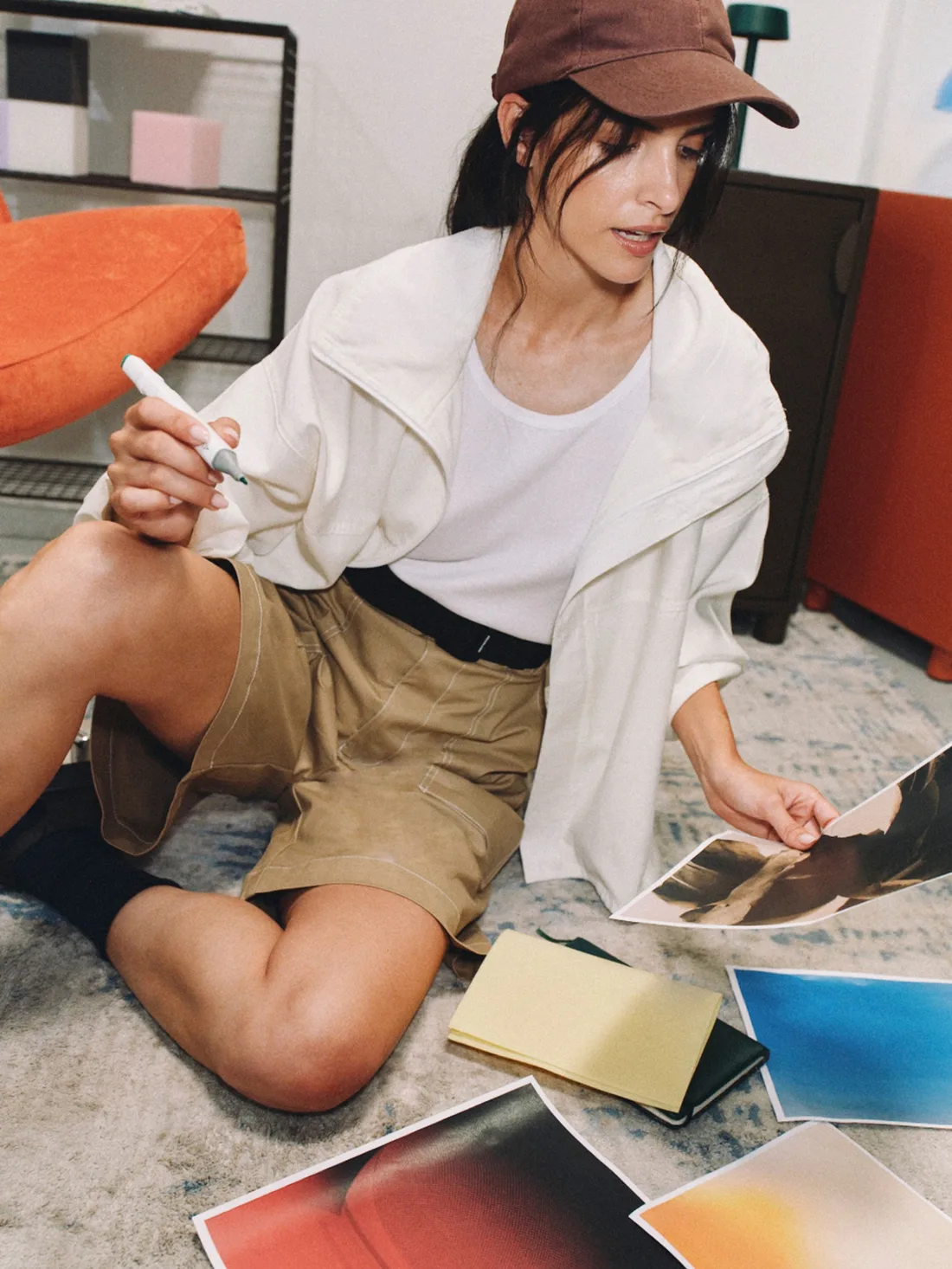 Focused and energized, sorting prints on the floor