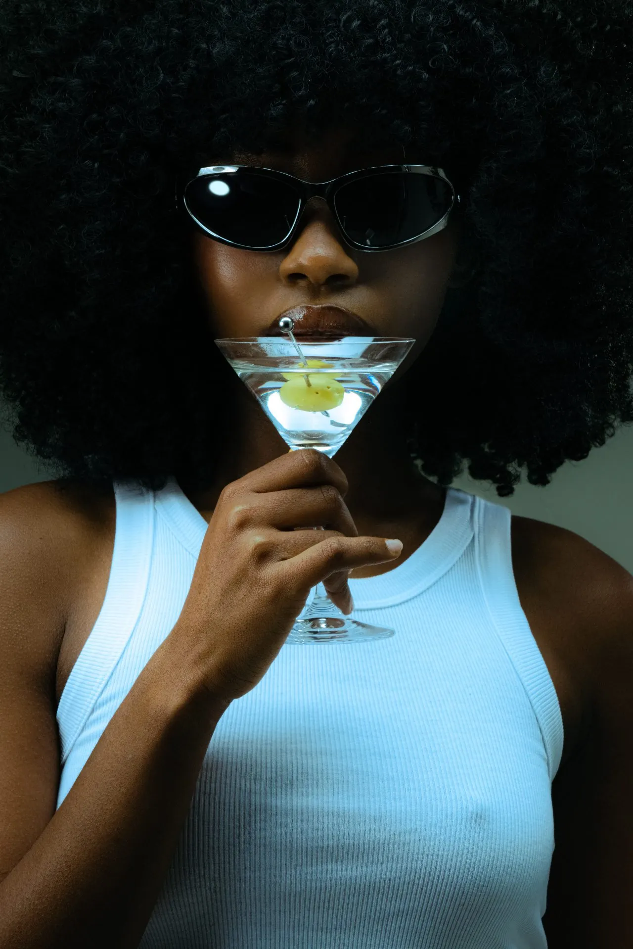 Woman in sunglasses holding a martini glass — Happy Hour at Rejuvia Wellness and Medical Spa in Uptown Dallas