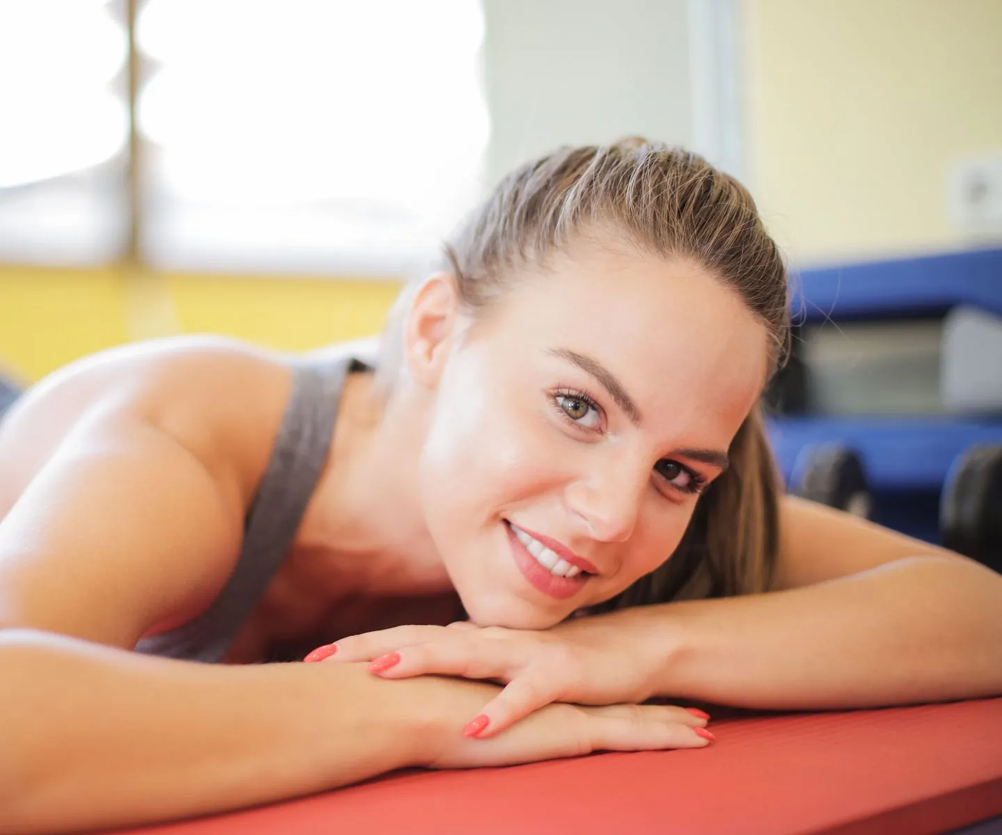 Woman resting on a yoga mat after a workout — wellness and functional medicine at Rejuvia Wellness and Medical Spa in Uptown Dallas