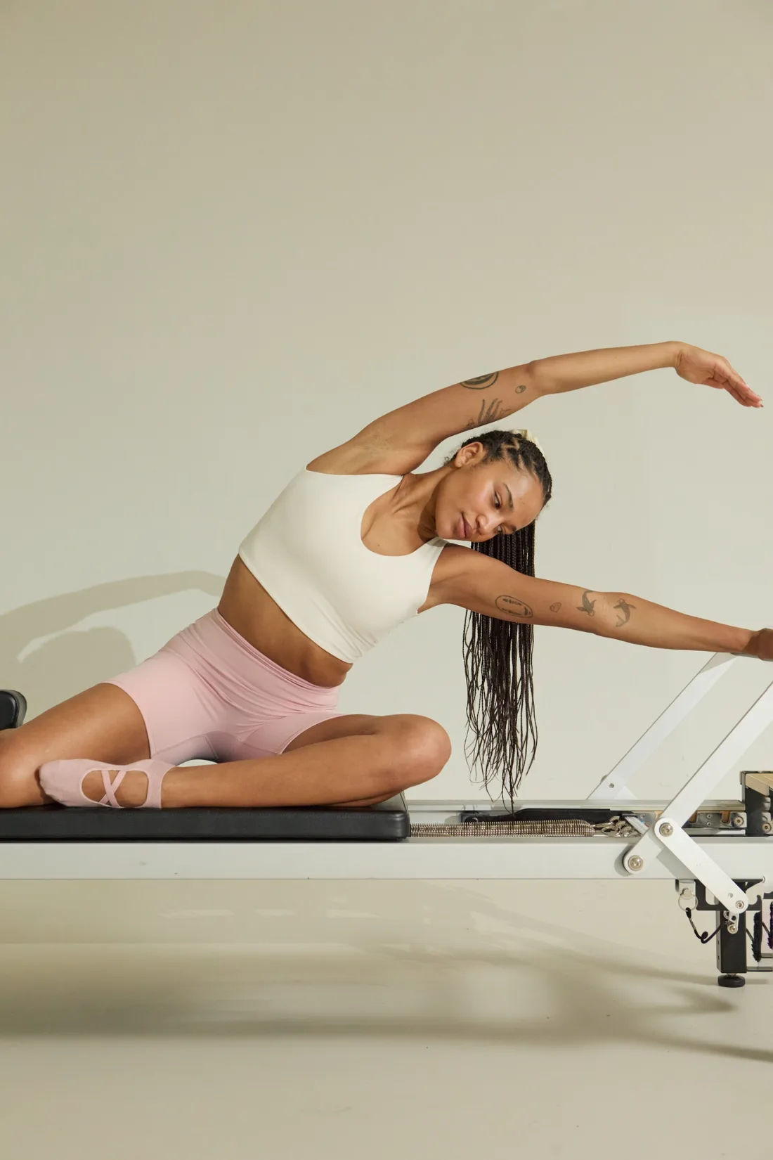 A graceful side stretch on the pilates reformer